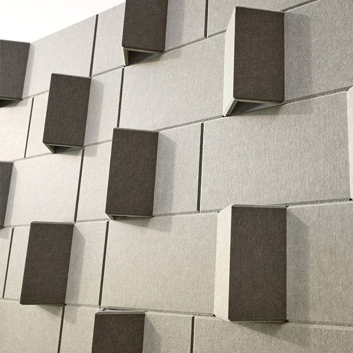 Sage green 3D acoustic wall panels featuring a modern geometric design on a wall.