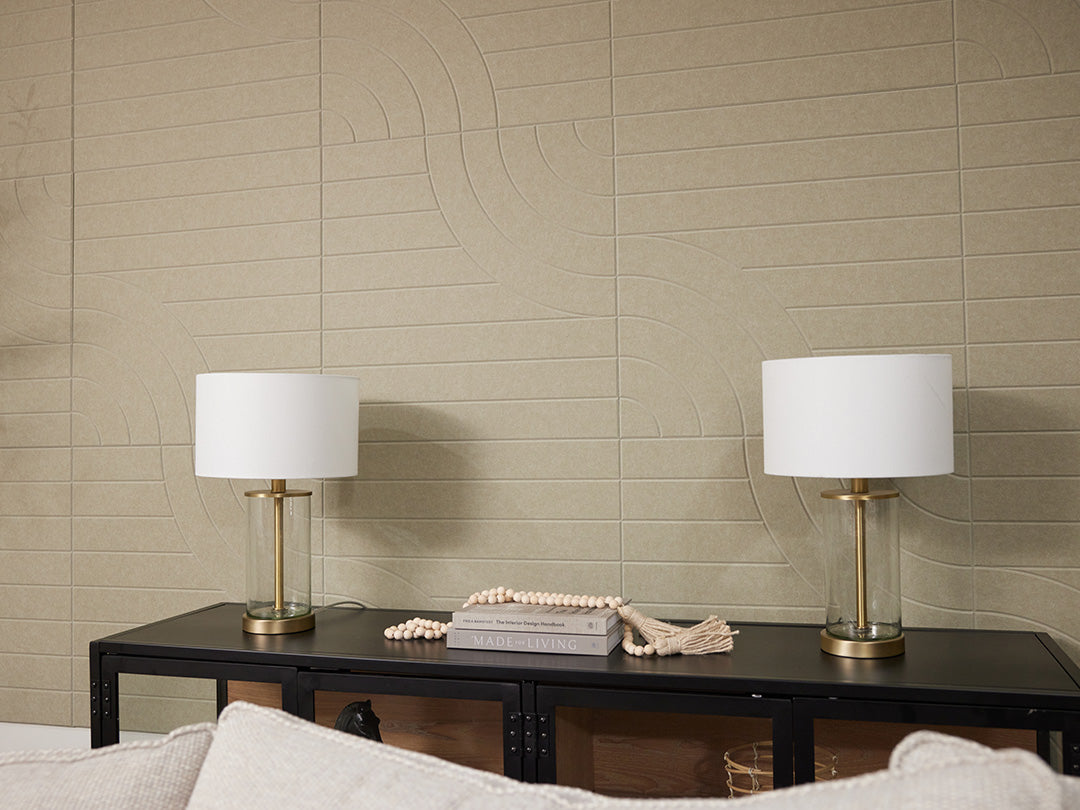 Felt Right acoustic panels in light sage green on wall behind couch next to a plant.