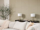 Felt Right acoustic panels in light sage green on wall behind couch next to a plant.