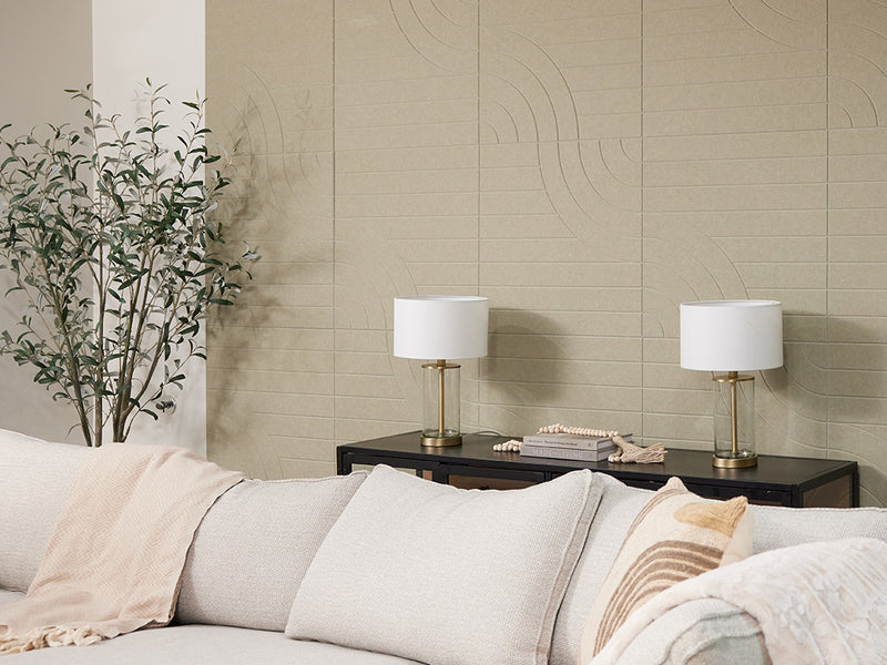 Felt Right acoustic panels in light sage green on wall behind couch next to a plant.