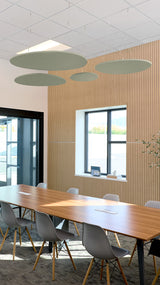 Modern conference room with wooden table, gray chairs, and large window.
