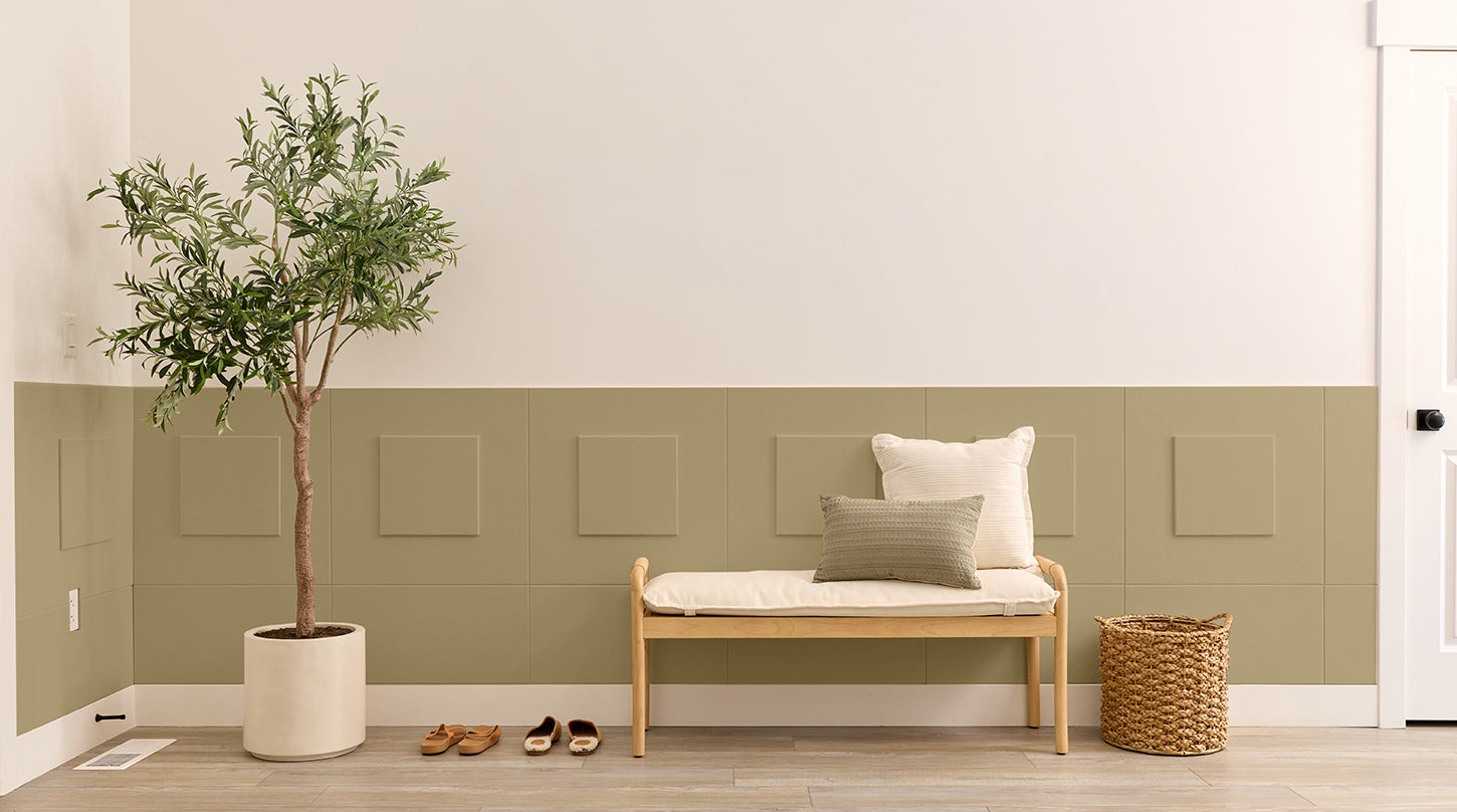 Entryway with wainscoting, a bench, and a tree.