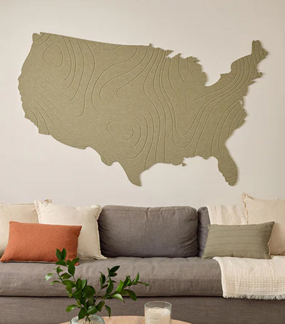 Wooden wall art of the United States in a living room setting