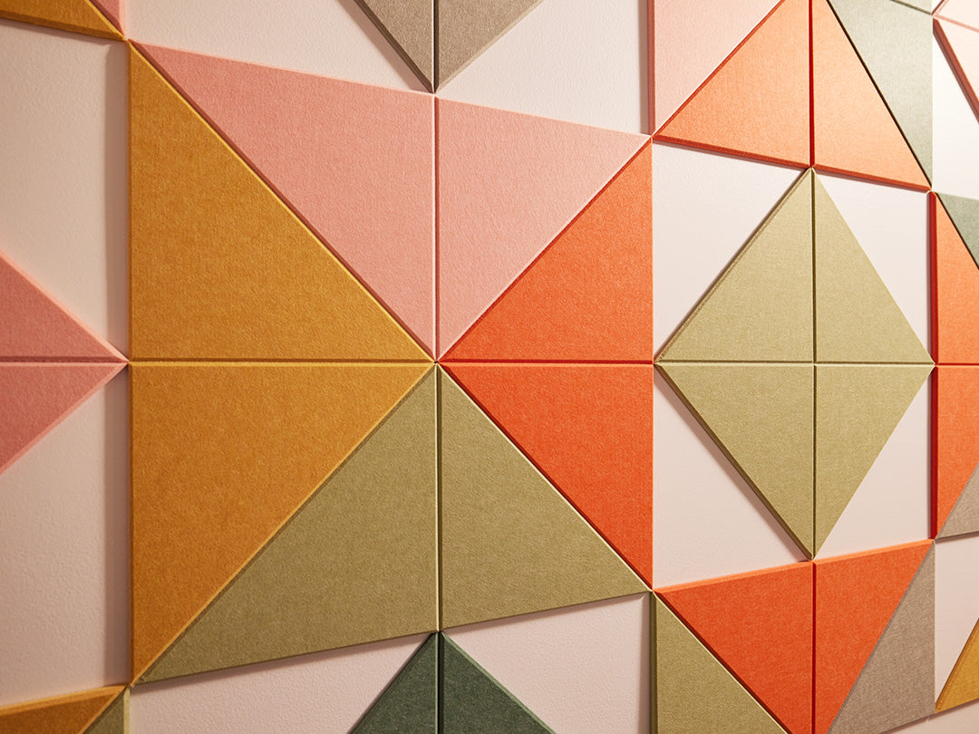 Felt Right wall art design in shades of green, orange, pink and yellow felt triangles creating a geometric pattern with negative spaces
