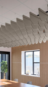 Light brownish-grey acoustic ceiling blade baffles suspended from the ceiling, installed in a conference room. Felt Right's acoustic blade baffles absorb 65% of sound waves, making office spaces quieter and feel more calm.