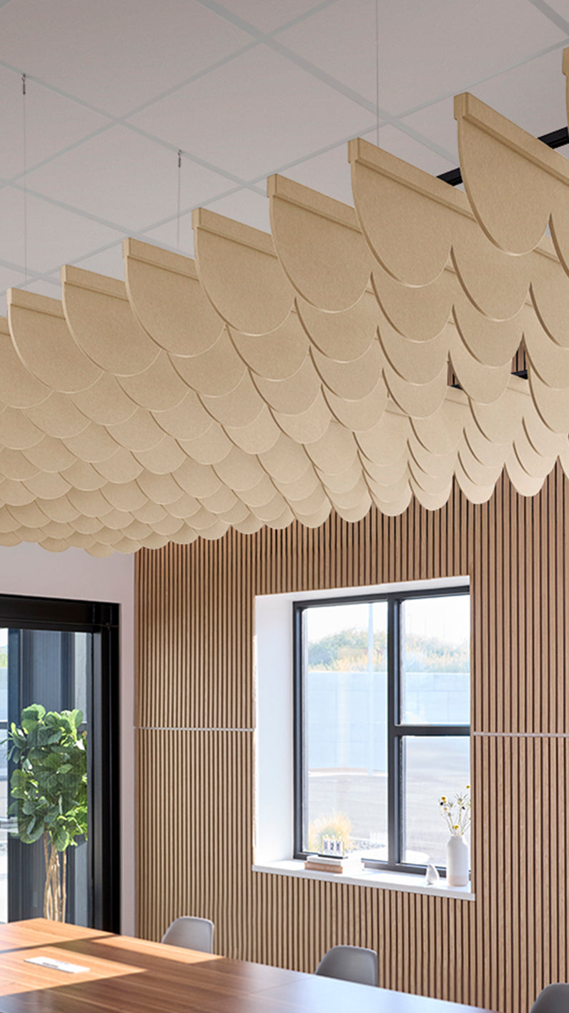 Light tan acoustic ceiling blade baffles suspended from the ceiling, installed in a conference room. Felt Right's acoustic blade baffles absorb 65% of sound waves, making office spaces quieter and feel more calm.