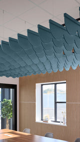 Teal blue acoustic ceiling blade baffles suspended from the ceiling, installed in a conference room. Felt Right's acoustic blade baffles absorb 65% of sound waves, making office spaces quieter and feel more calm.
