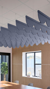 Indigo blue acoustic ceiling blade baffles suspended from the ceiling, installed in a conference room. Felt Right's acoustic blade baffles absorb 65% of sound waves, making office spaces quieter and feel more calm.