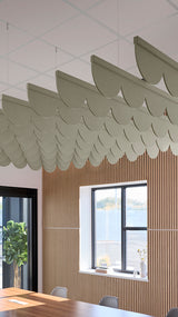 Soft green acoustic ceiling blade baffles suspended from the ceiling, installed in a conference room. Felt Right's acoustic blade baffles absorb 65% of sound waves, making office spaces quieter and feel more calm.