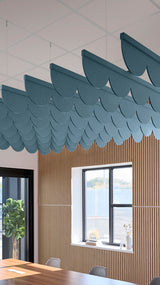Teal blue acoustic ceiling blade baffles suspended from the ceiling, installed in a conference room. Felt Right's acoustic blade baffles absorb 65% of sound waves, making office spaces quieter and feel more calm.