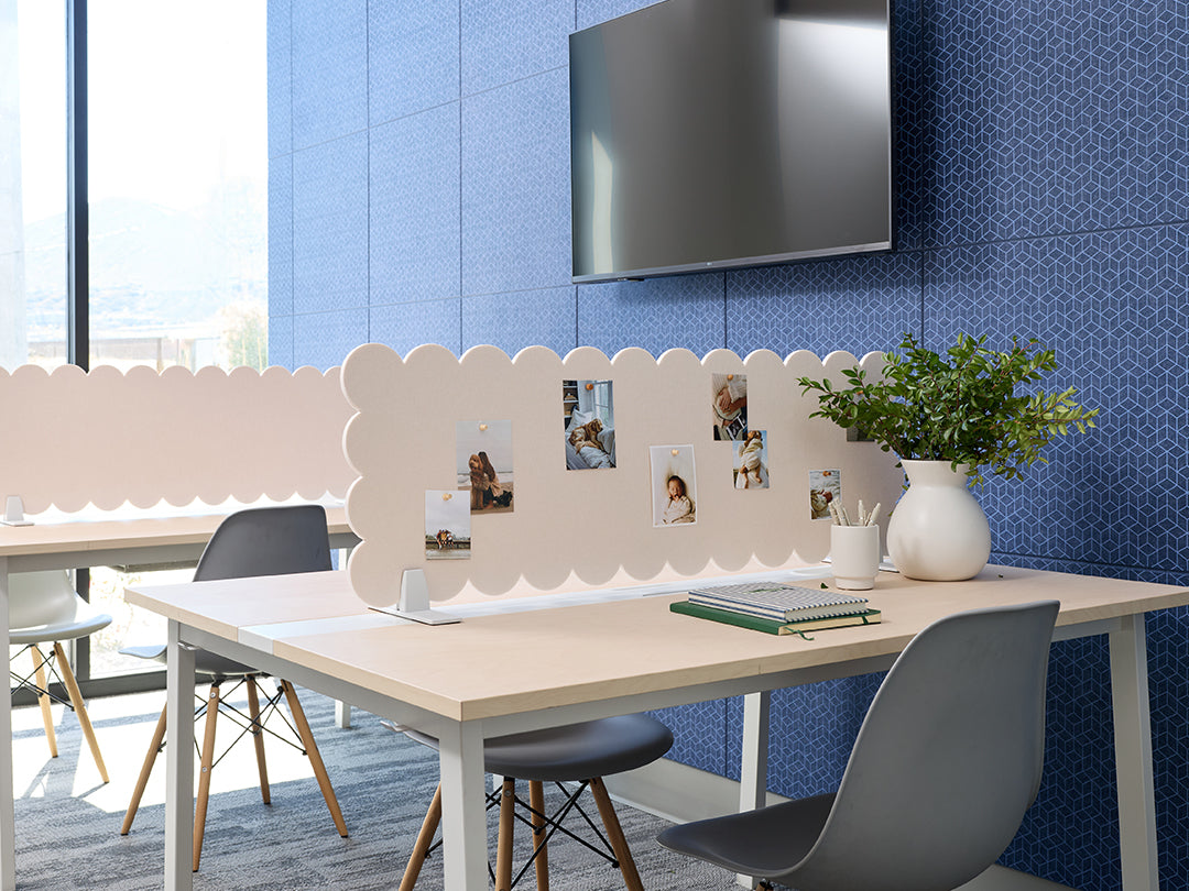 Modern office setup with a desk, chairs, and decorative elements against a blue tiled wall.