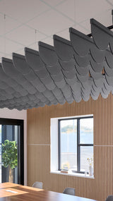 Gray scalloped acoustic baffles suspended from ceiling above wooden wall paneling in modern interior space.
