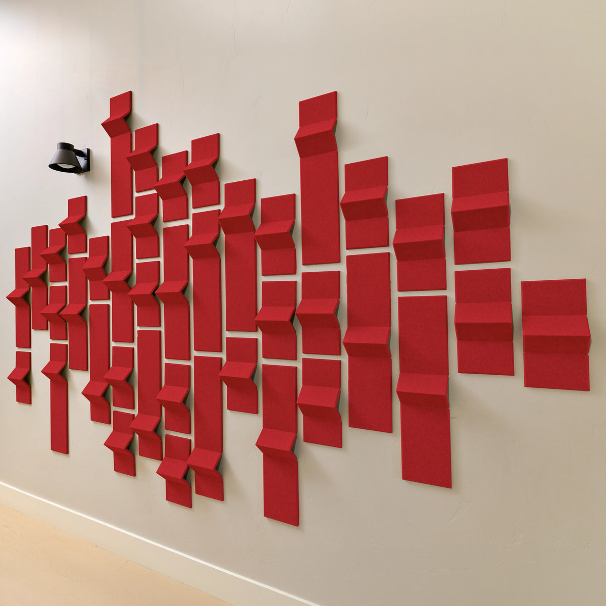 Red acoustic felt tiles with 3D points along a wall
