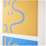 Yellow and blue abstract canvas art with curved wavy lines on wooden wall.