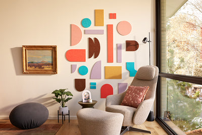 Bright Felt Right tiles installed on wall behind armchair. 