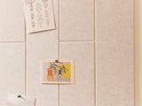 felt right cream tiles in the shiplap patter with cards pinned onto the felt tiles