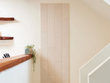 Beige shiplap wall paneling with vertical board pattern and grooved detailing in modern interior space.