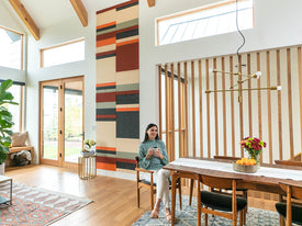 Modern living room with a colorful wall hanging.