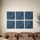 Six blue felt acoustic tiles in a 3D peak design above a sofa