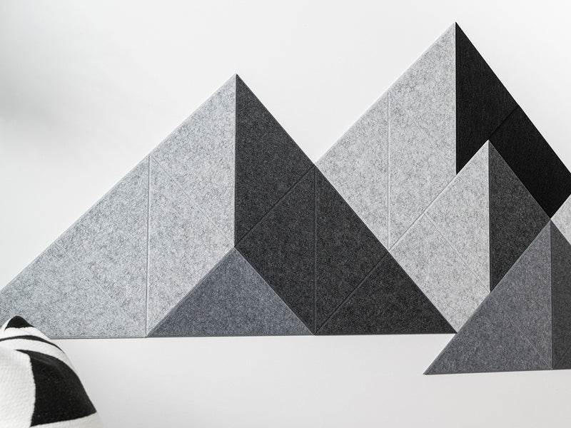 A Felt Right wall art design in shades of grey in a mountain design on a white wall 