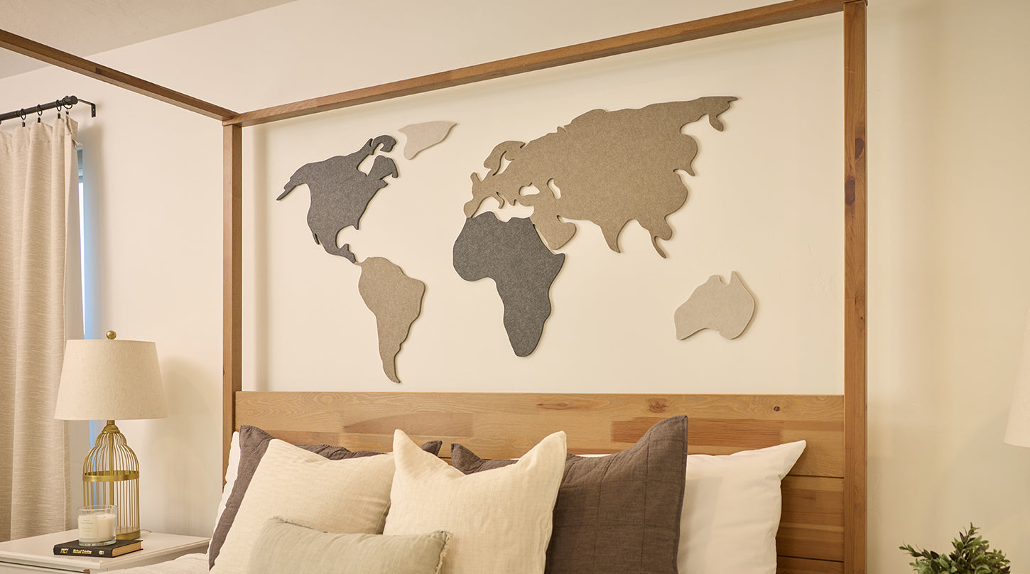 World map wall art above bed