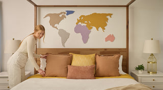 world map wall art above bed