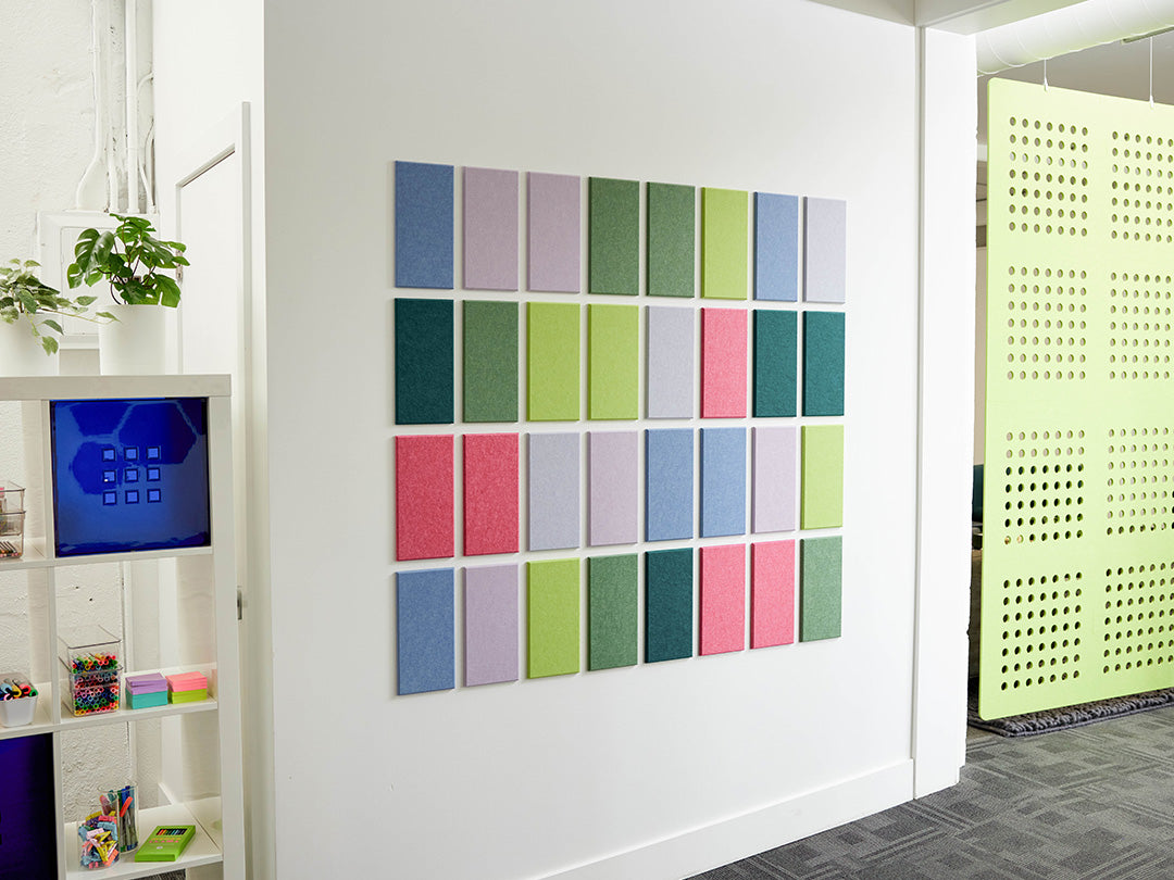 Color swatch panel on a white wall with a modern interior setting.