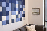 Blue and white checkered wall tiles with sparkly finish arranged in horizontal pattern on interior wall.