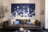 Horizontal wall art with blue, gray, and cream pixelated squares in gradient pattern.
