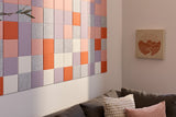 Horizontal wall art with colorful grid pattern in orange, purple, gray, cream, and pink tiles with sparkly finish.