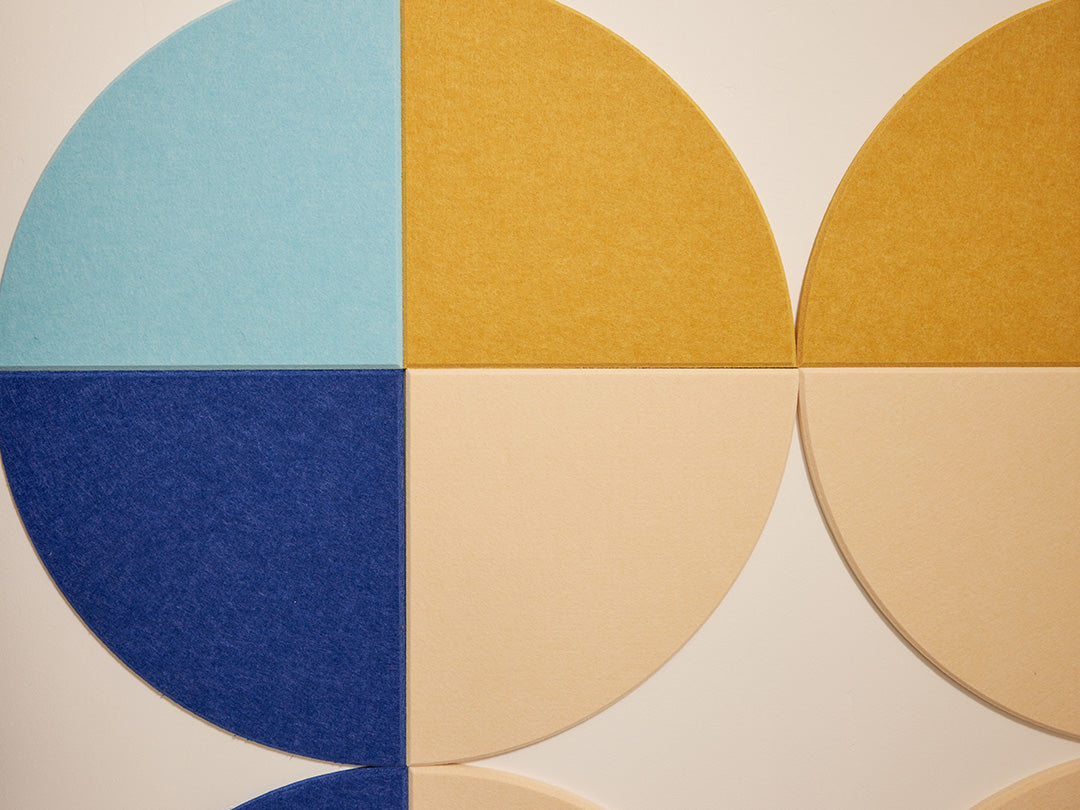Colorful acoustic art in blue, yellow, and beige on a neutral background
