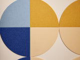 Felt Right wall art using quarter circles of felt in shades of yellow and blue.