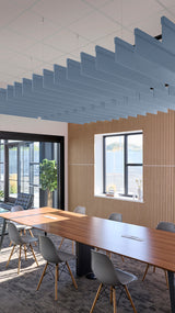 Blue straight acoustic baffle panels suspended from ceiling in office conference room.