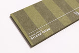 Close up of a green, striped acoustic felt sample 