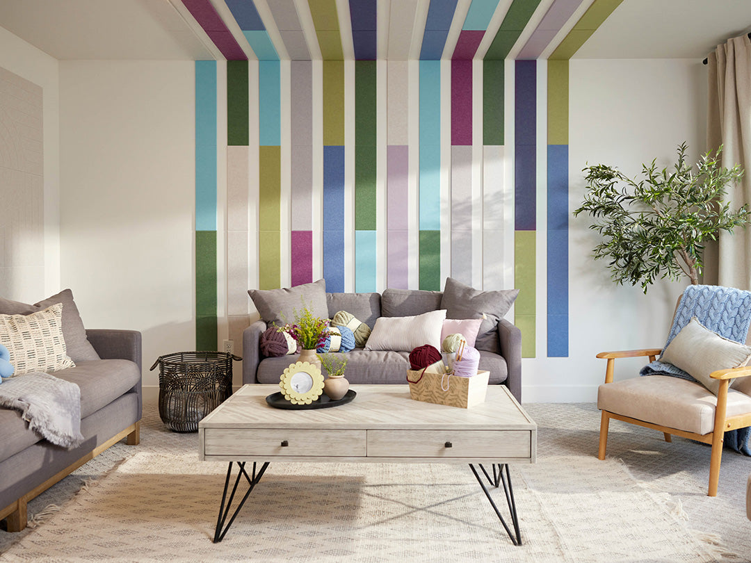 Living room with colorful striped wall, gray sofa, and wooden coffee table.