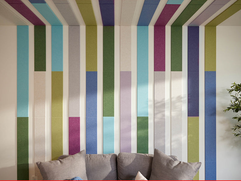 Colorful striped wall with a gray sofa in the foreground