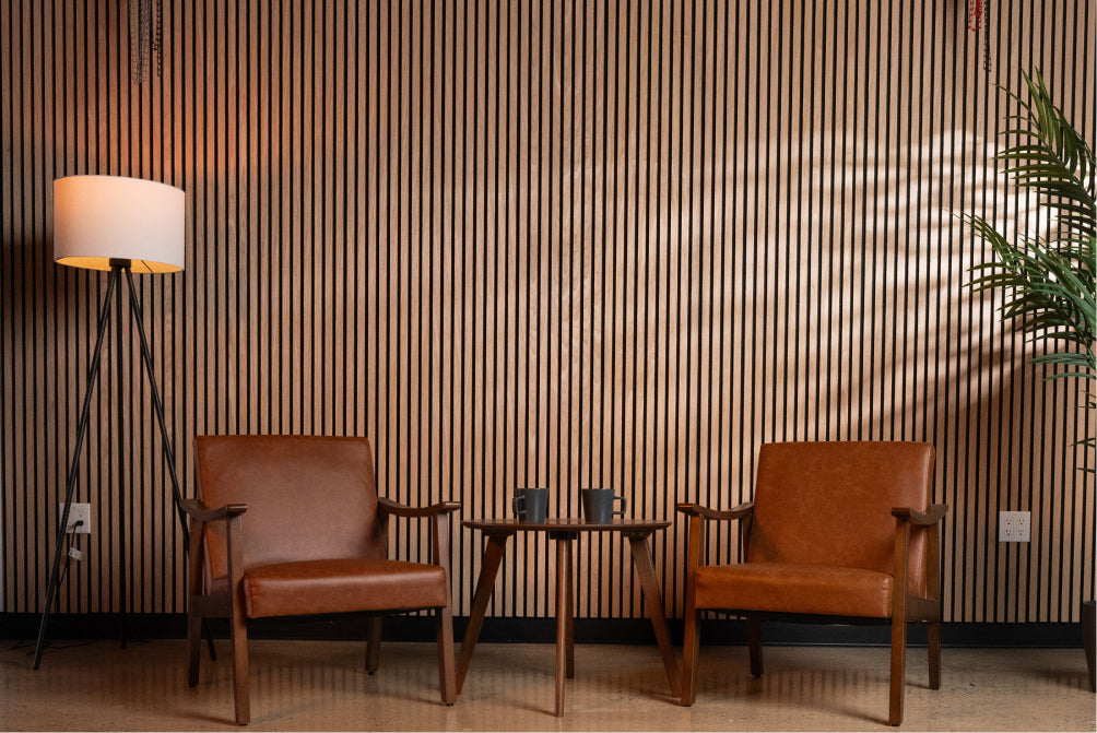 Wall to wall acoustic wood slat wall panels in modern minimal podcast or sitting area