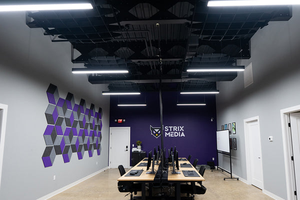 Modern office space with Strix Media logo on a purple wall