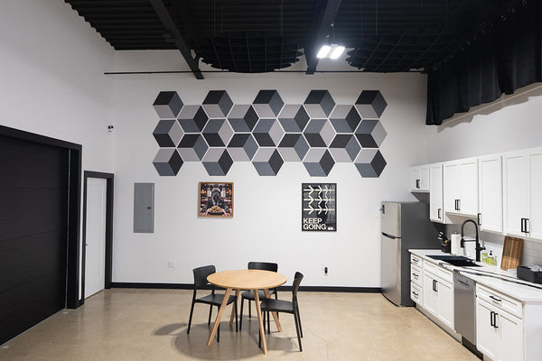 Modern kitchen with geometric wall art and dining area