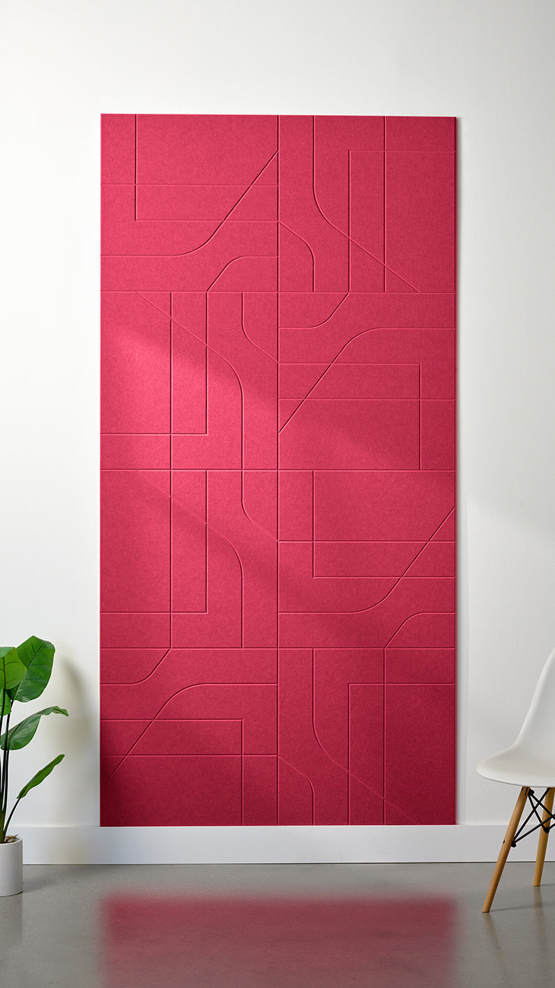 Red Felt Right 4’ x 8’ PET felt panel with intersecting lines similar to a transit system map engraved into the material against a white wall. A plant and chair are in the foreground.