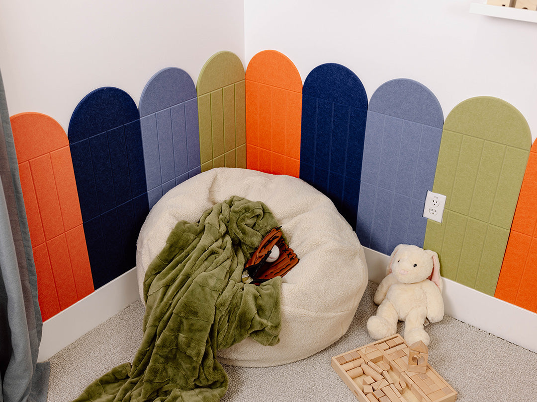 Children's room with colorful wall panels, bean bag chair, and toys.