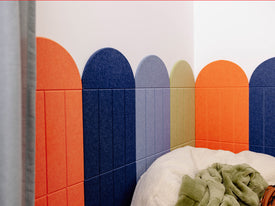 Children's room with colorful wall panels, bean bag chair, and toys.