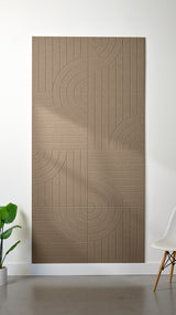 Lighter Brown Felt Right 4’ x 8’ PET felt panel with straight and circular lines engraved into the material against a white wall. A plant and chair are in the foreground.