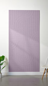 Light purple Felt Right 4’ x 8’ PET felt panel with straight and circular lines engraved into the material against a white wall. A plant and chair are in the foreground.