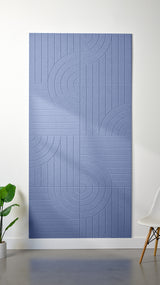 Periwinkle Felt Right 4’ x 8’ PET felt panel with straight and circular lines engraved into the material against a white wall. A plant and chair are in the foreground.