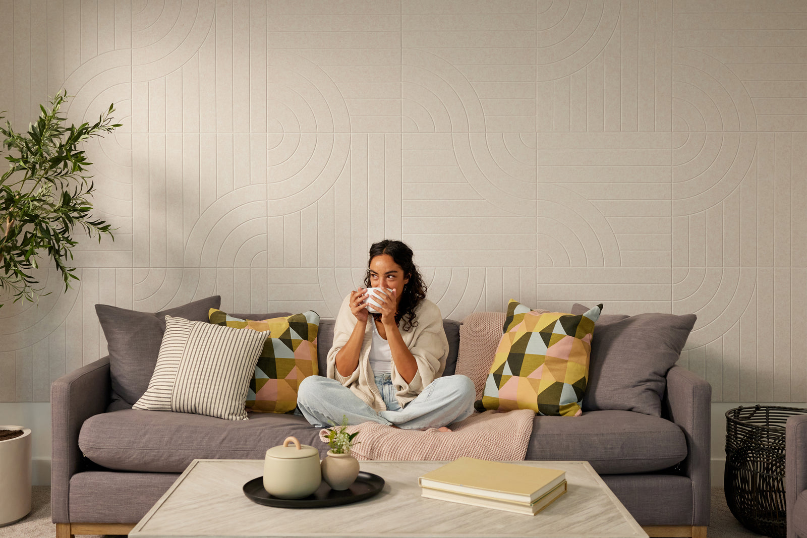 Felt Right wall tangent design in a cream color tangent line pattern displayed in living room behind a couch.