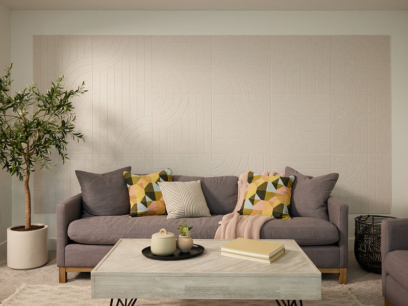 Living room with a gray sofa, colorful cushions, and a coffee table.