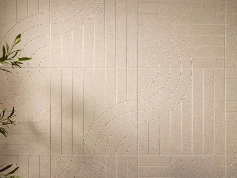 Beige tiles with circular patterns on a wall