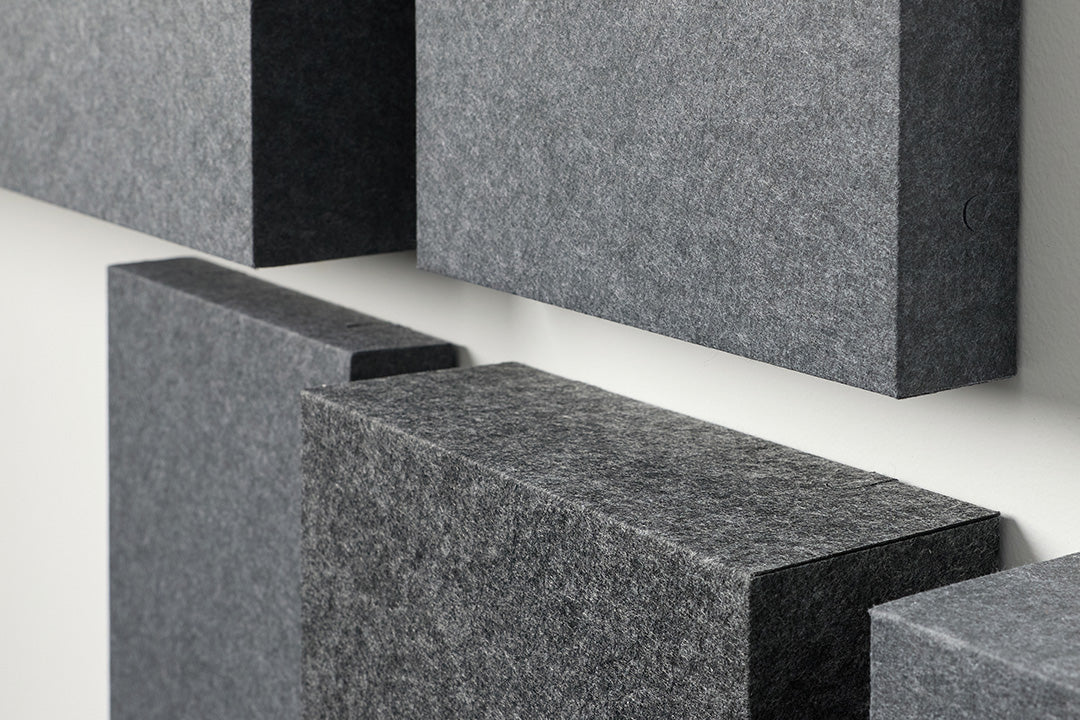 Gray acoustic blocks arranged in a geometric pattern on a white background