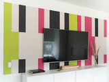Pink and green wall art behind Tv